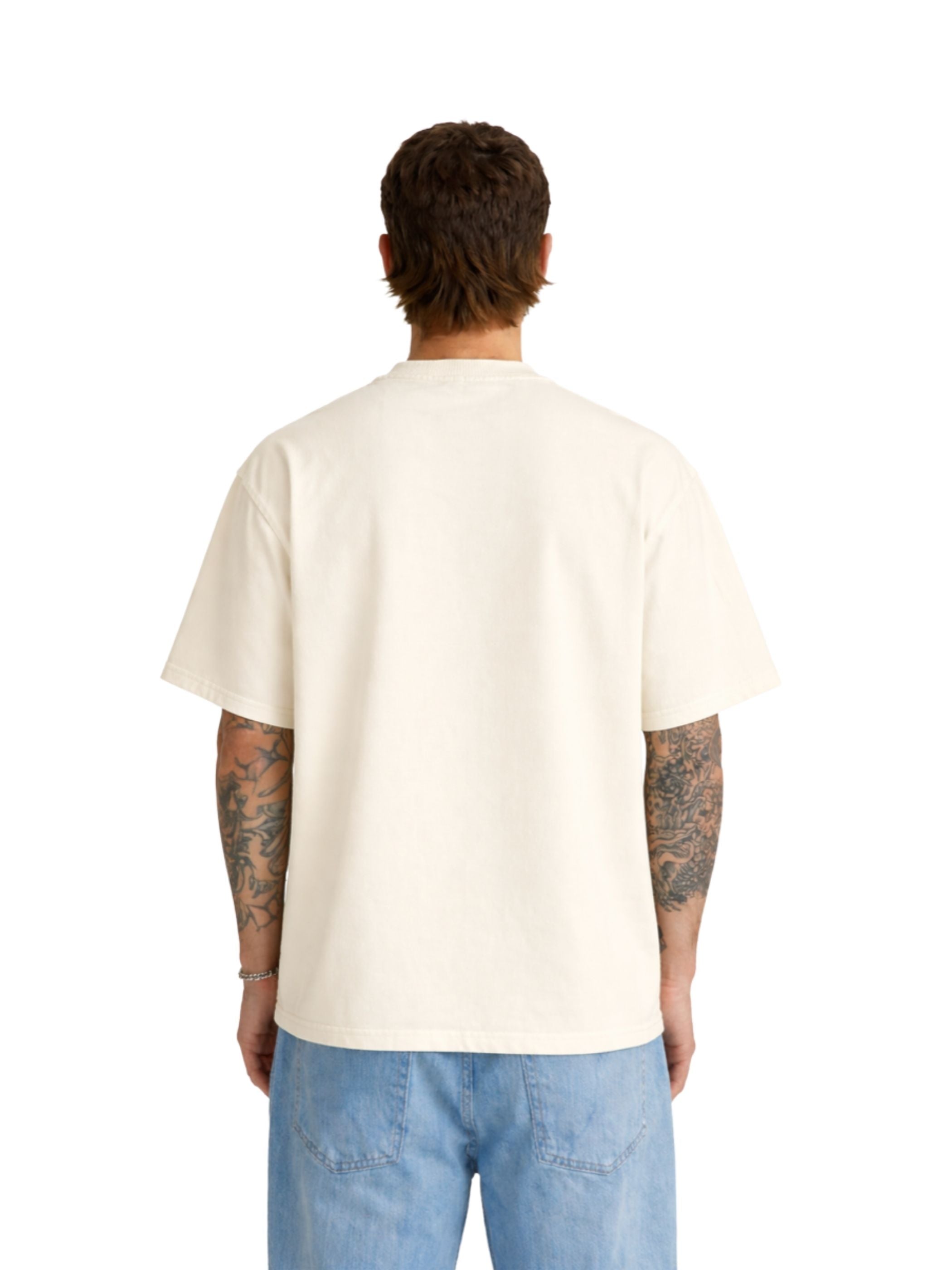 Person wearing a beige t-shirt and blue jeans on a white background