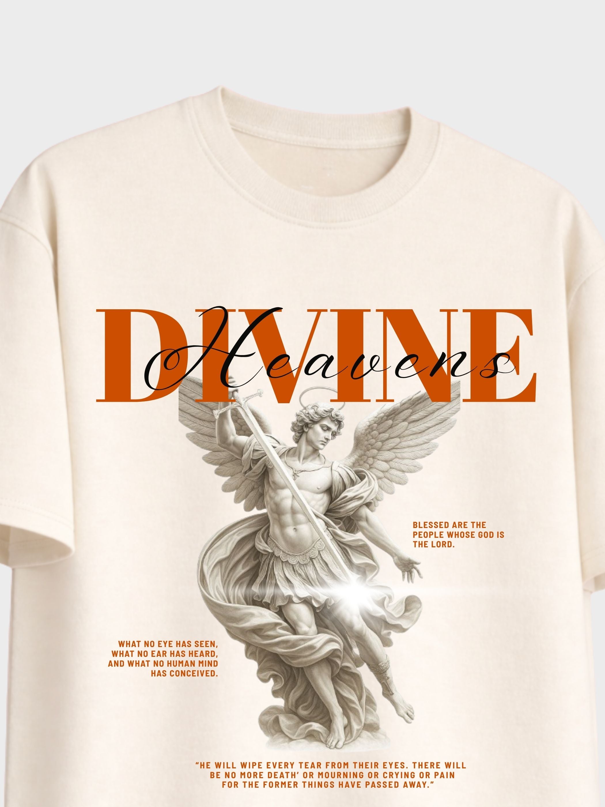 An off-white short-sleeve t-shirt featuring a graphic print of a classical winged angel statue with the word 'Heavens' in orange and black script, accompanied by inspirational quotes.