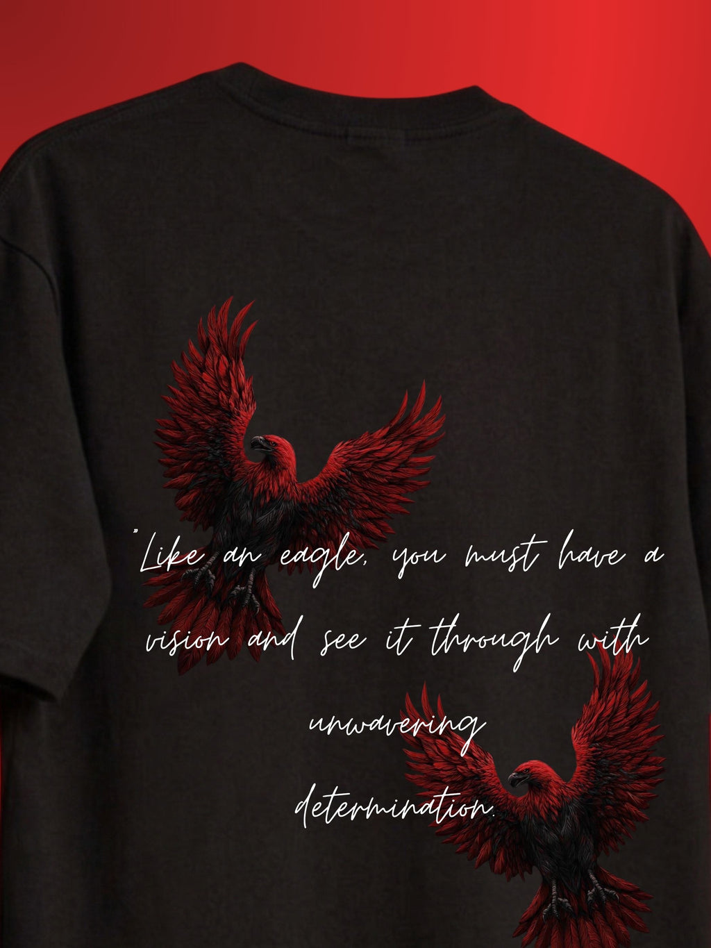 A black t-shirt featuring two red and black eagle illustrations and a white quote printed on the front, set against a solid red background.