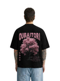Model wearing Oubaitori Blk black boxy fit T-shirt with pink tree graphic on back