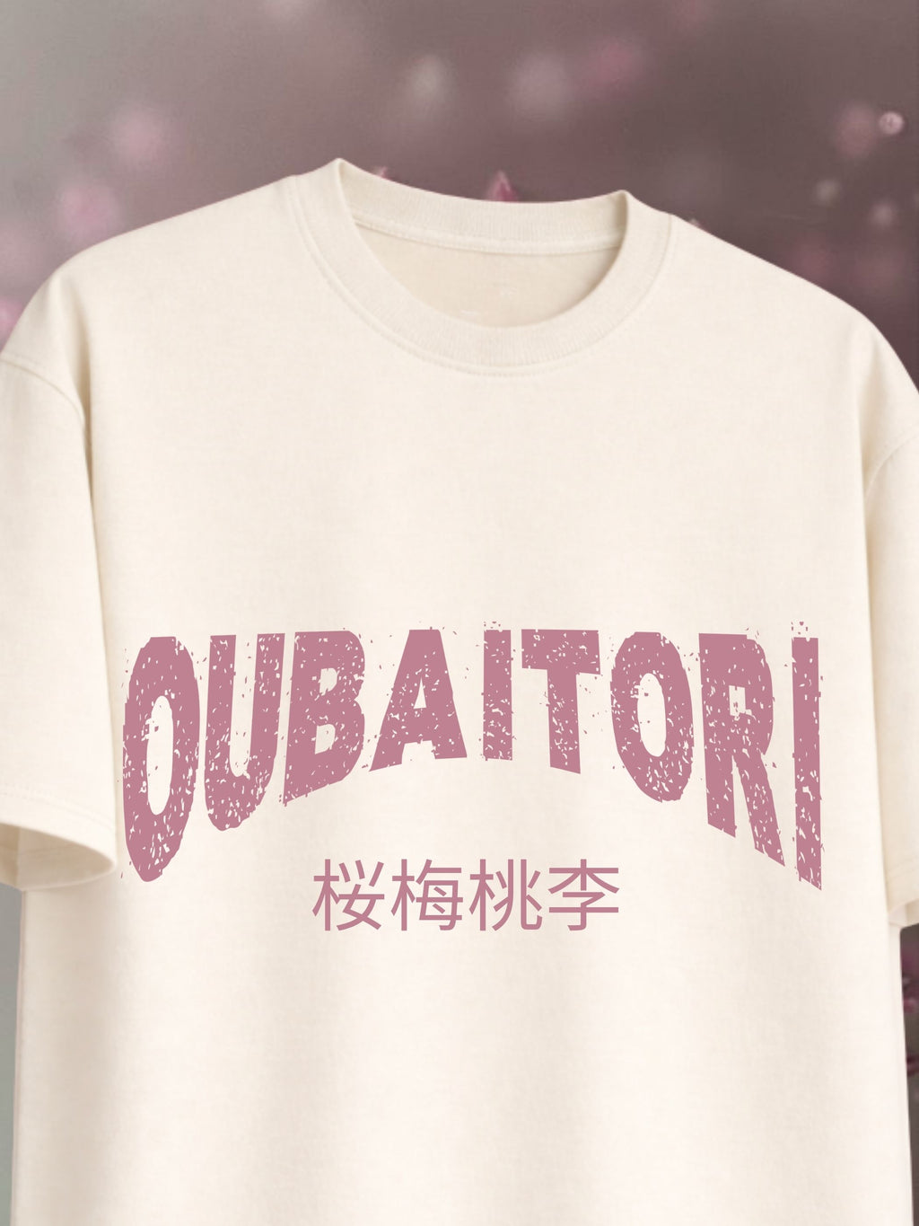 White t-shirt with pink text 'OUBAITORI' on a blurred background